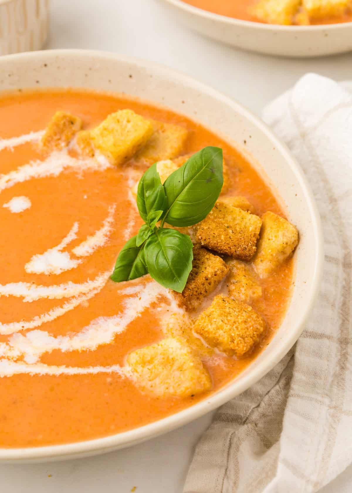 Tomato Basil Bisque served with fresh basil.