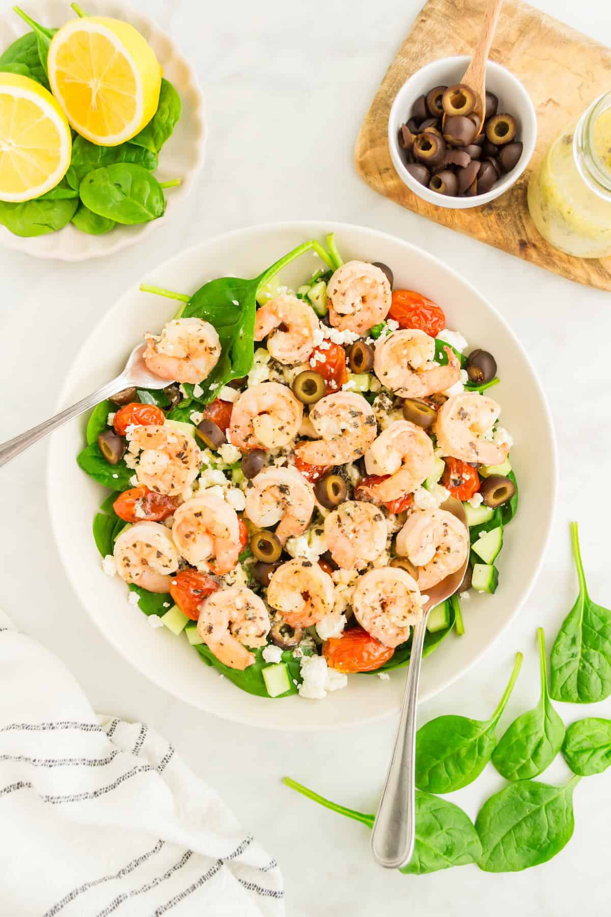 Greek Shrimp Salad served with dressing and extra olives.