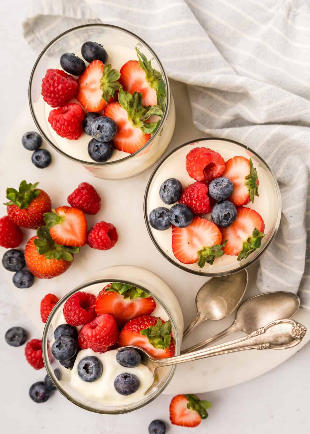 top down shot of no bake cheesecake cups topped with berries