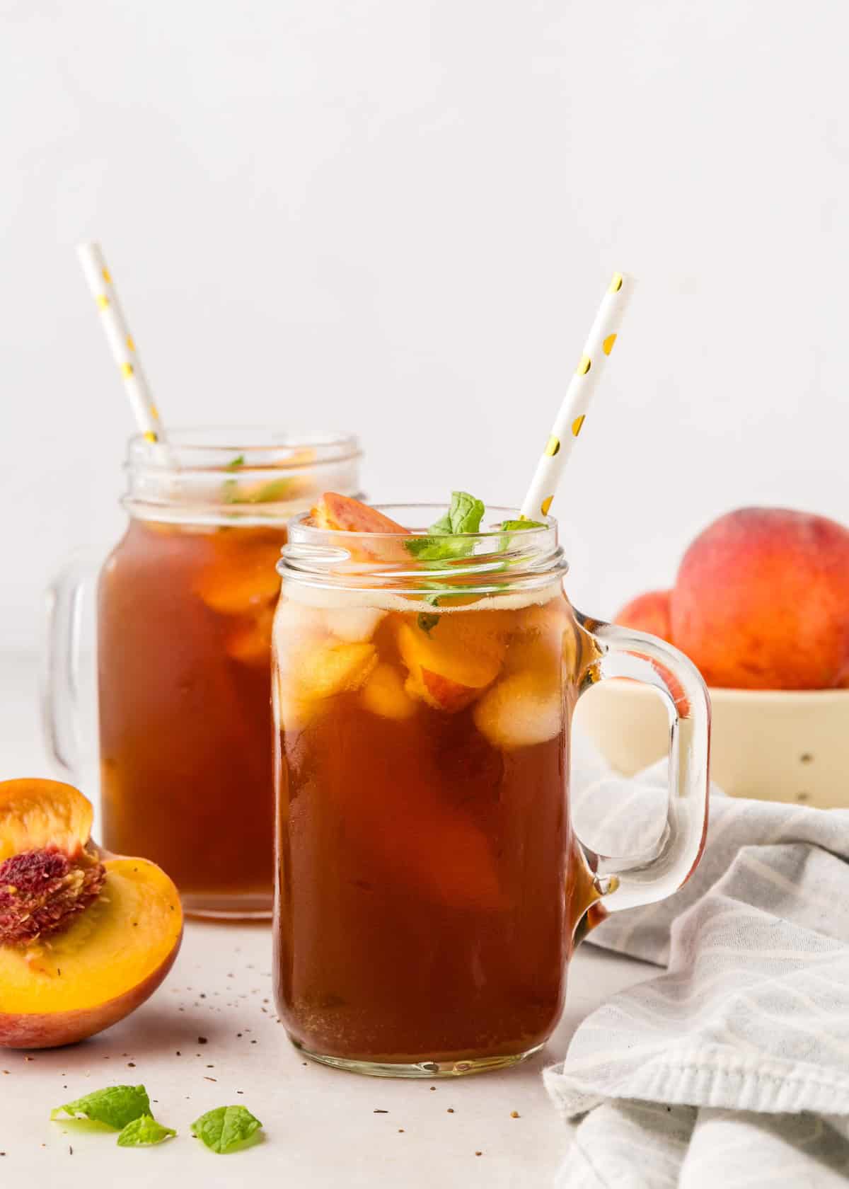 peach iced tea served in glass mugs