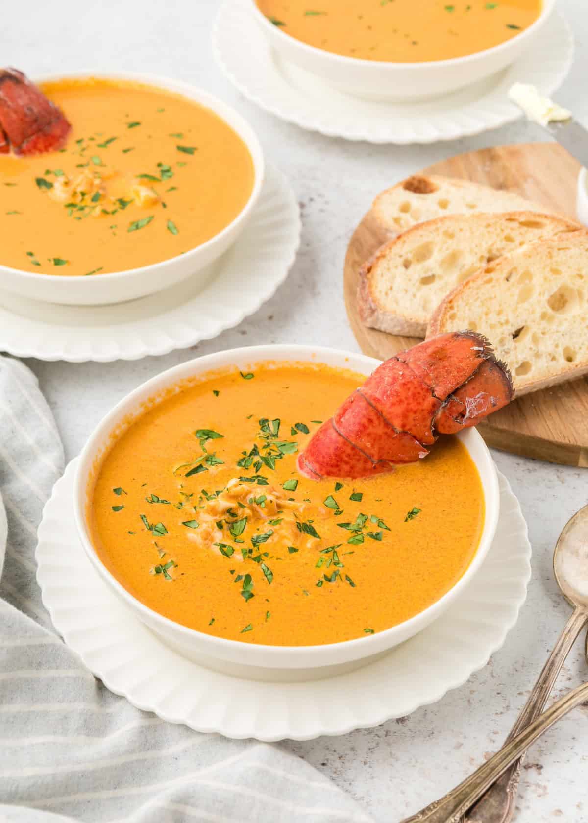 Lobster Bisque with tail sticking out of bowl.