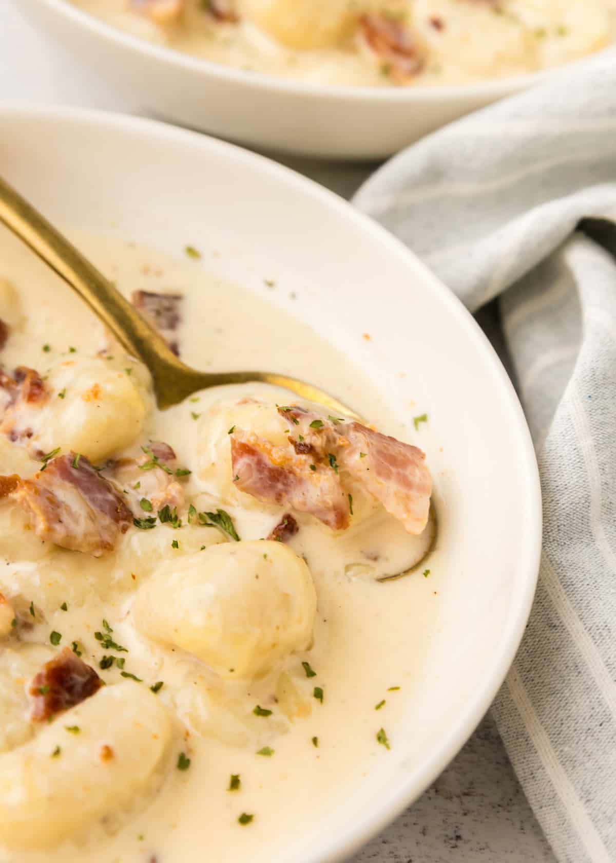 Soup scooped with golden spoon.