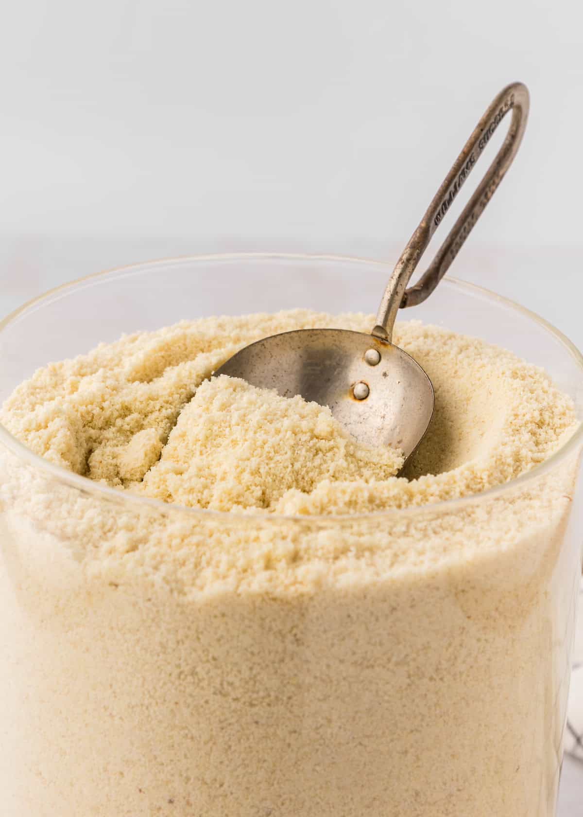 Almond Meal in a jar with scoop.