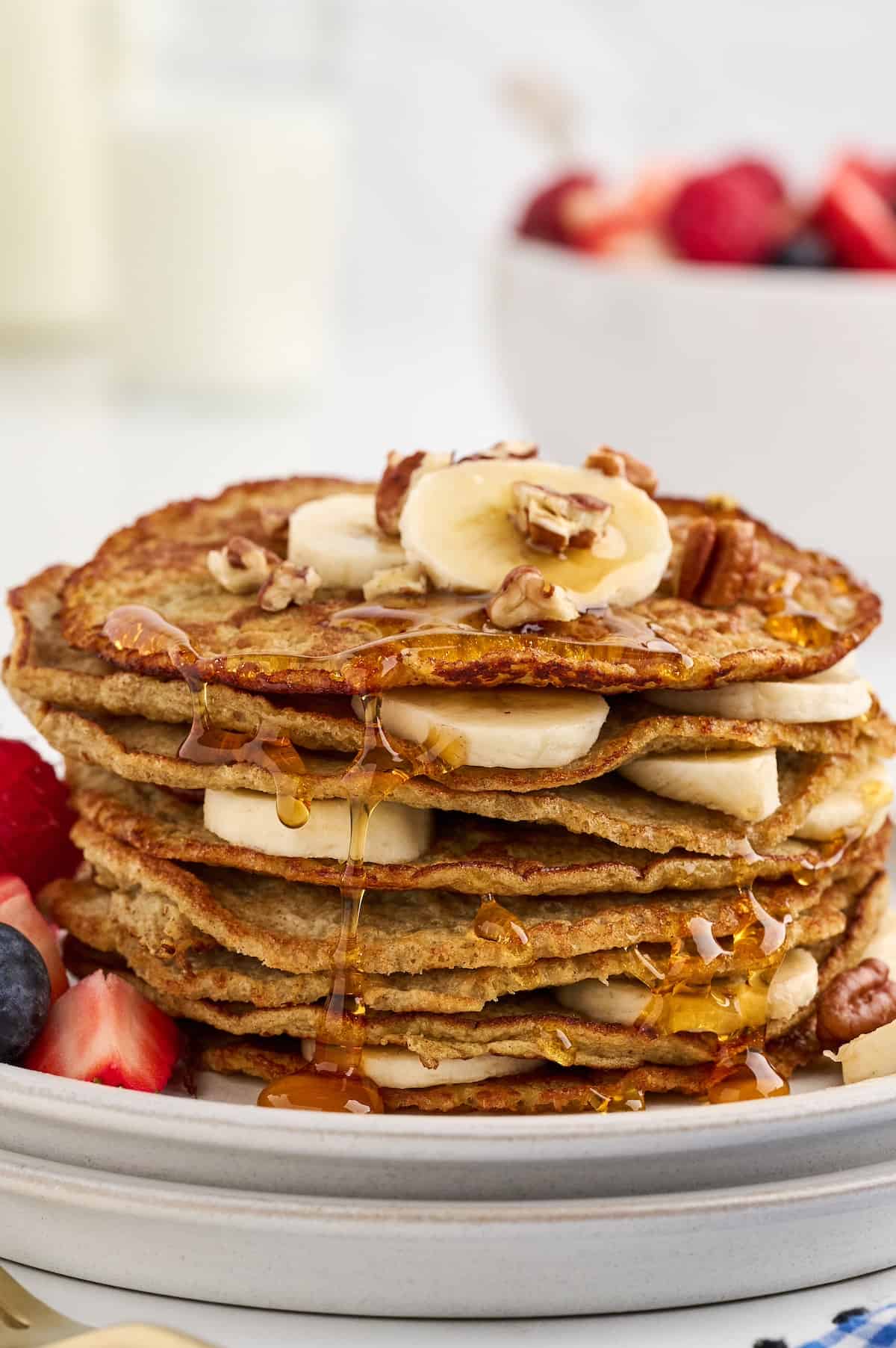 Easy 3 ingredient banana pancakes with syrup and bananas.