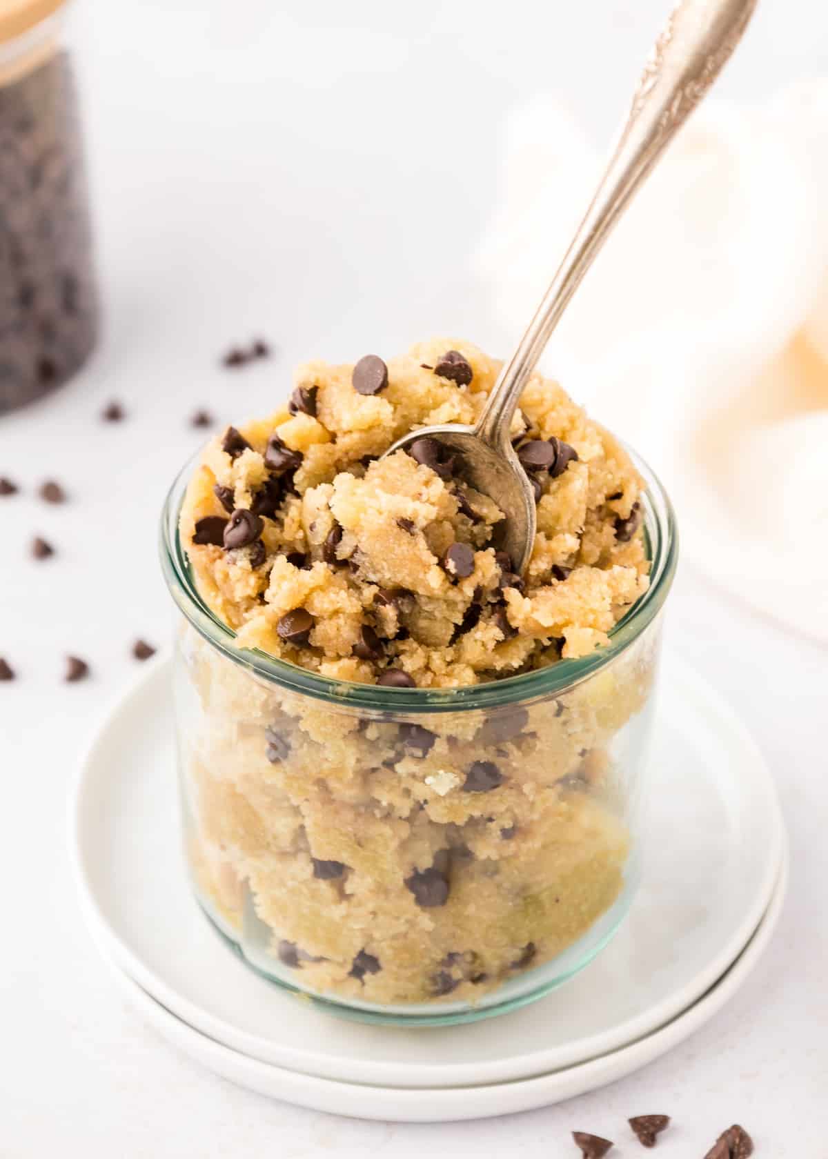 Edible cookie dough in jar with spoon,