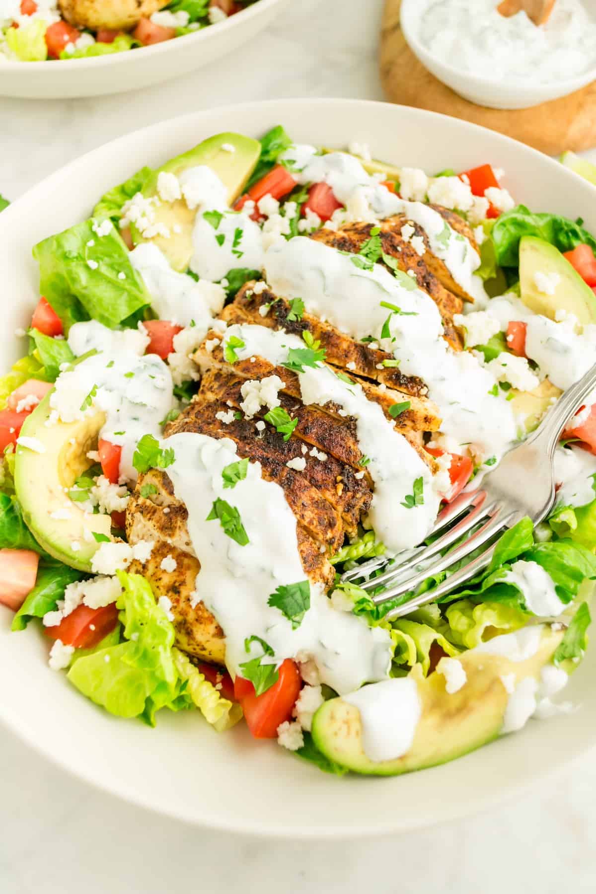chili lime chicken salad served and topped with dressing