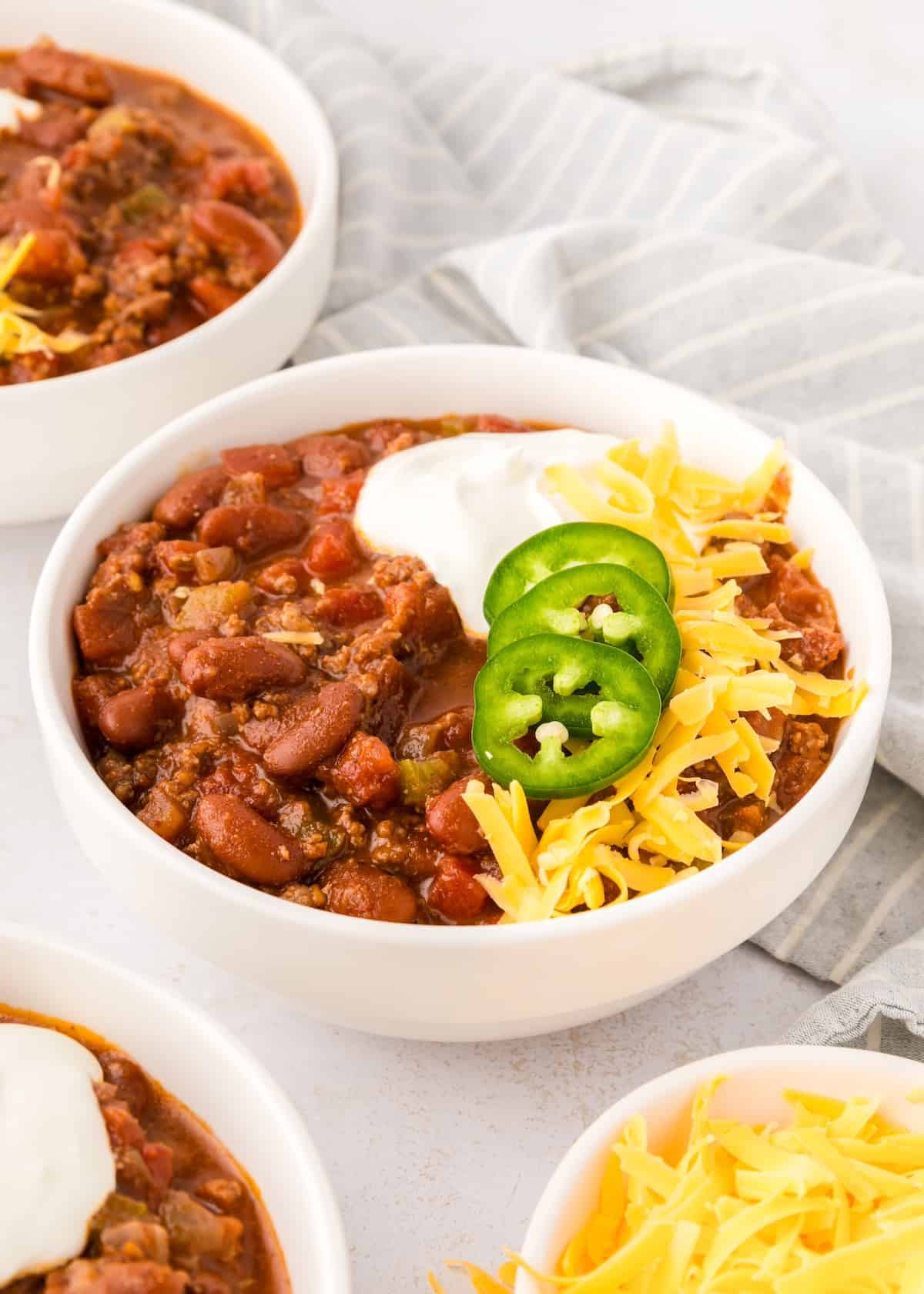 Instant pot chili topped and served in white bowls.
