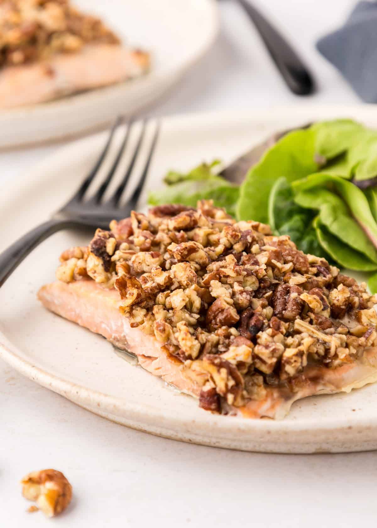 Salmon crusted with pecans, served with greens.