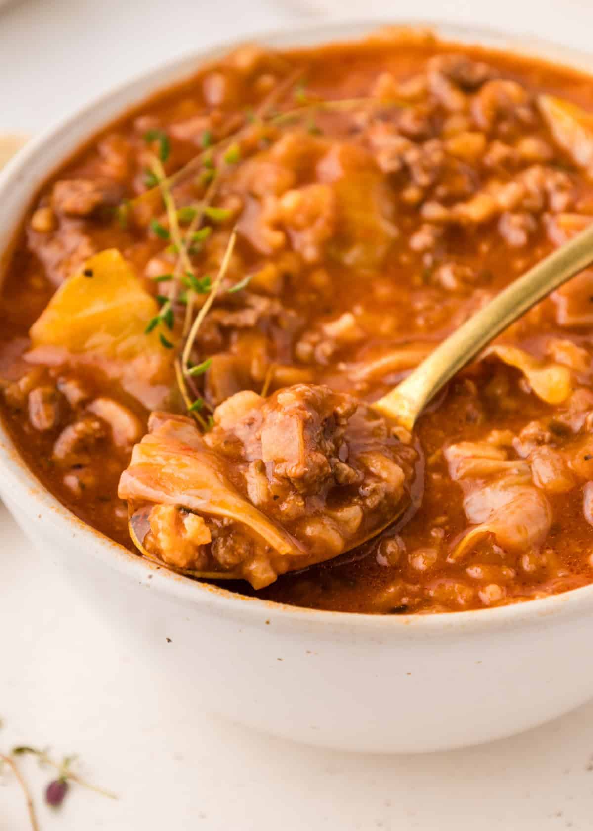 cabbage roll soup served in bowl with spoon