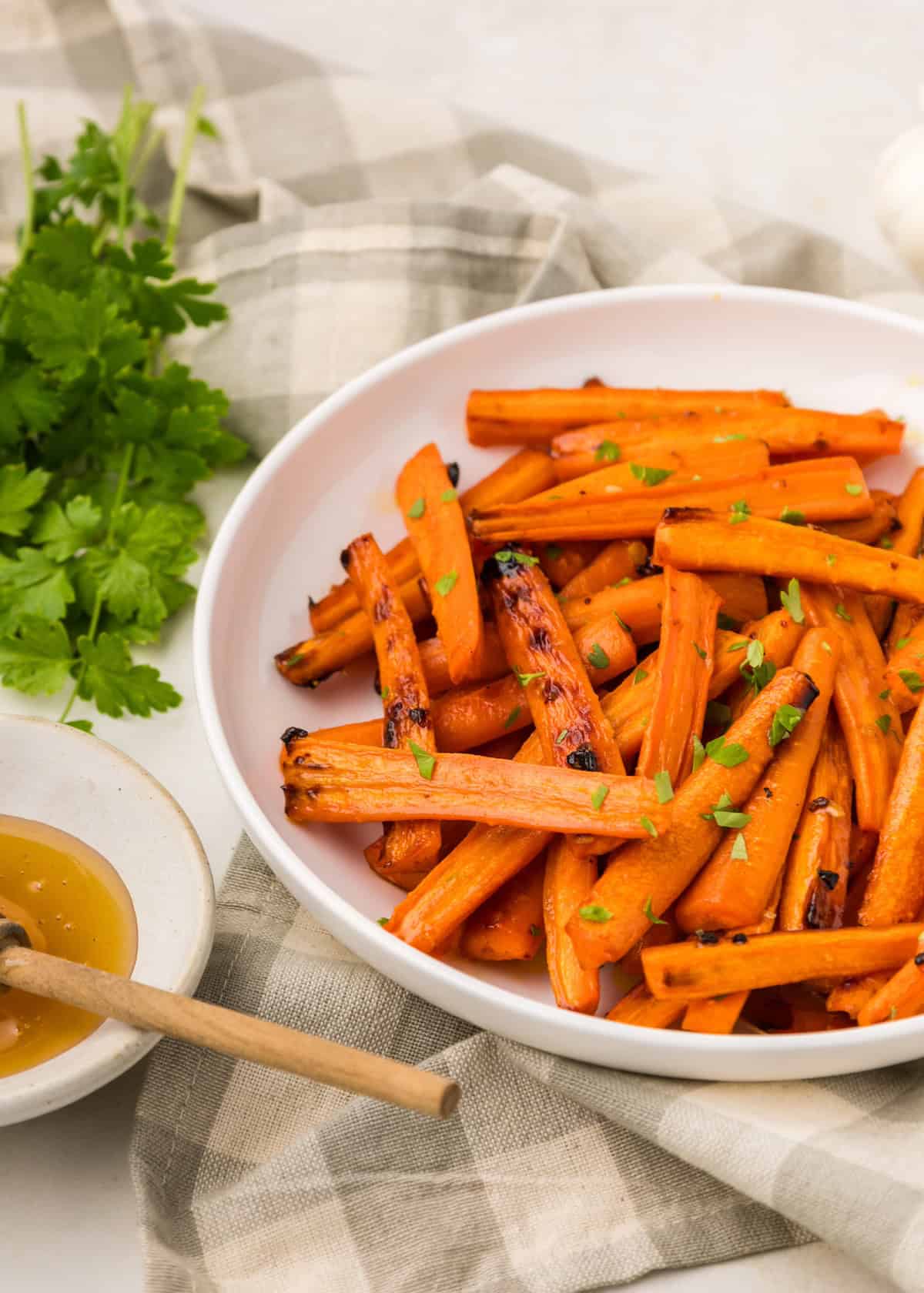 honey garlic carrots served on dish with honey