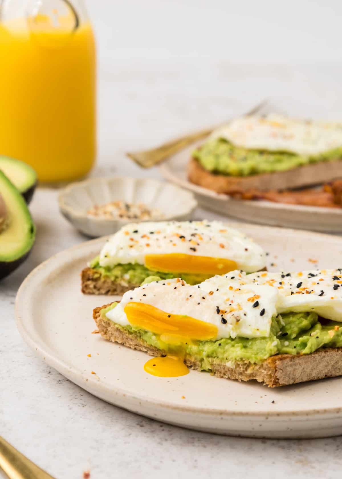 Avocado Egg toast with egg yolk running out.