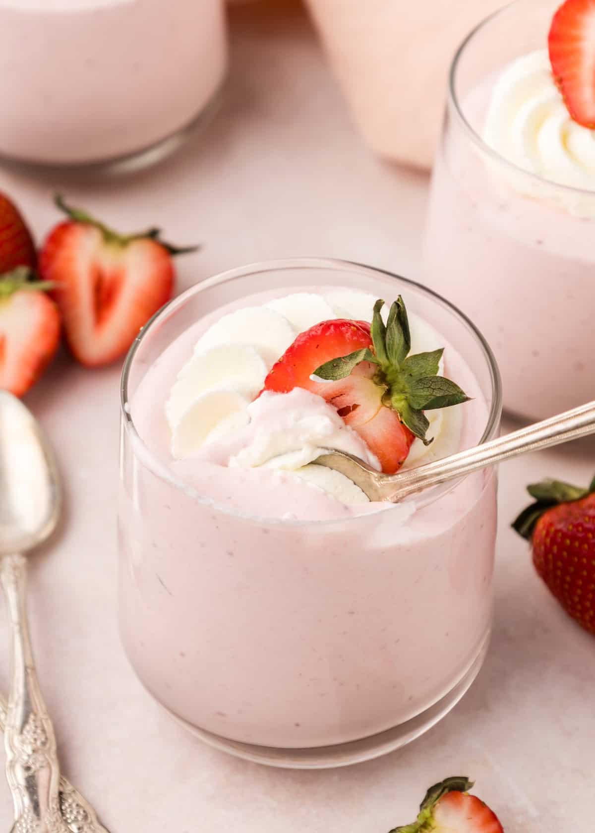 Strawberry Mousse in a glass with spoon and topping.