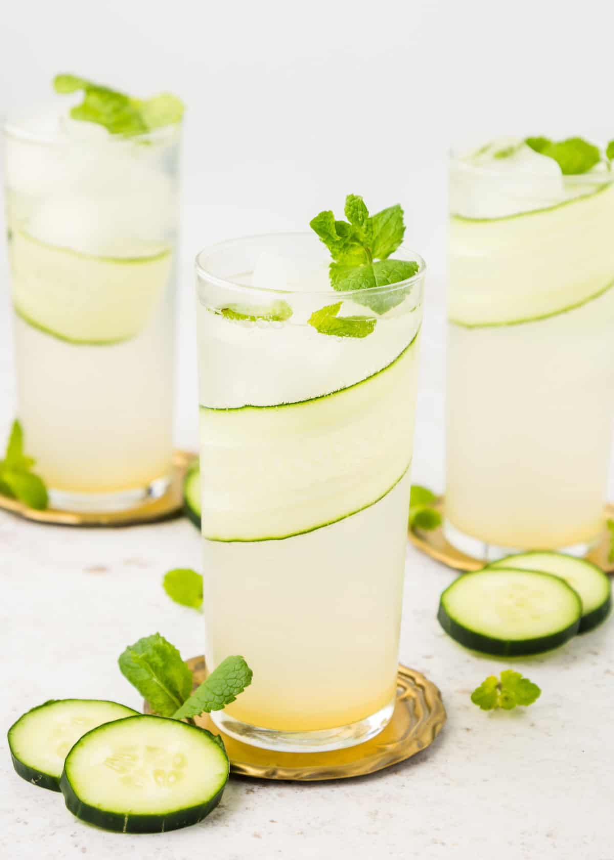 Cucumber Mint Cooler served in tall galsses with slices of cucumber.