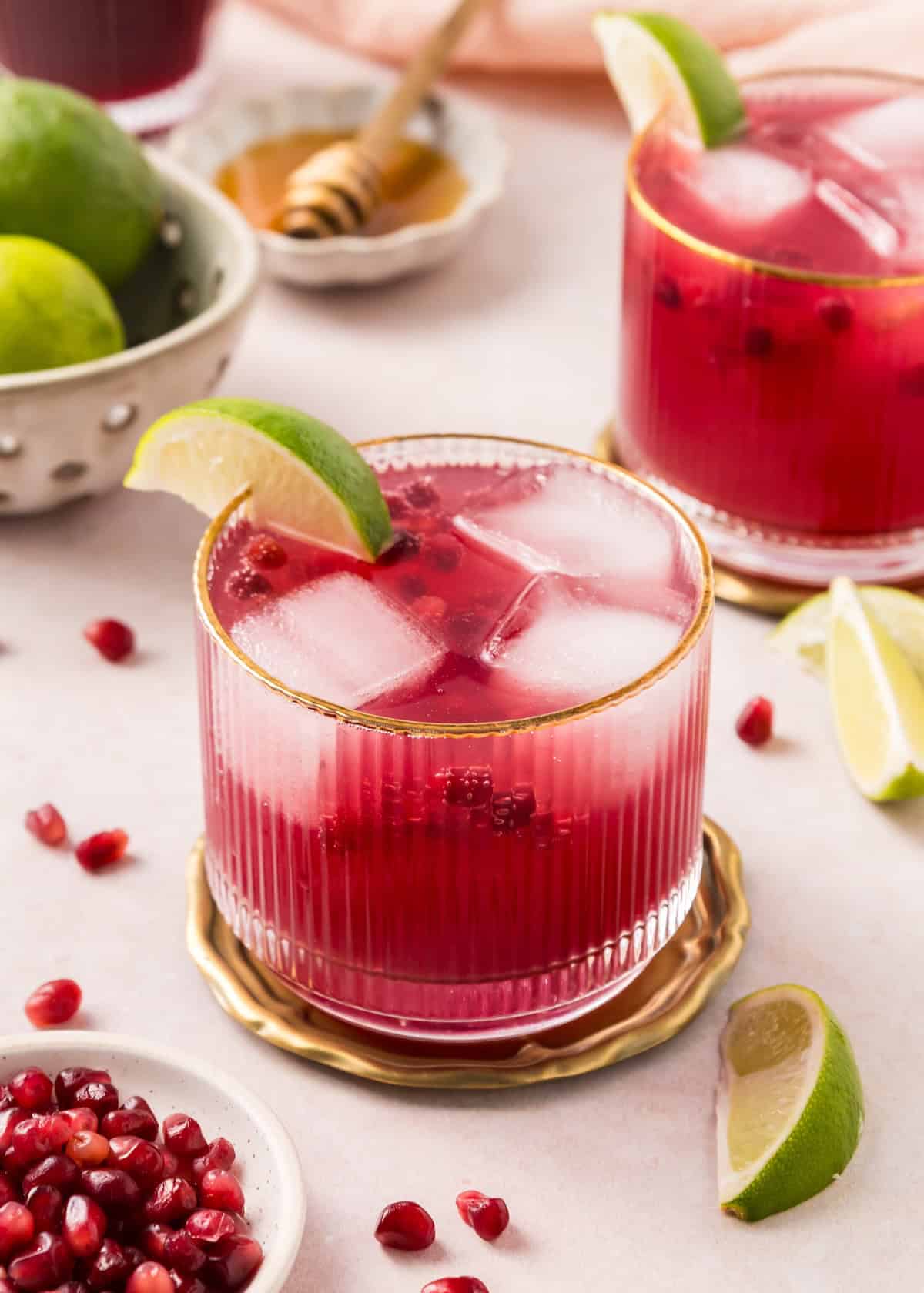 Pomegranate Mocktails in gold rimmed glasses.