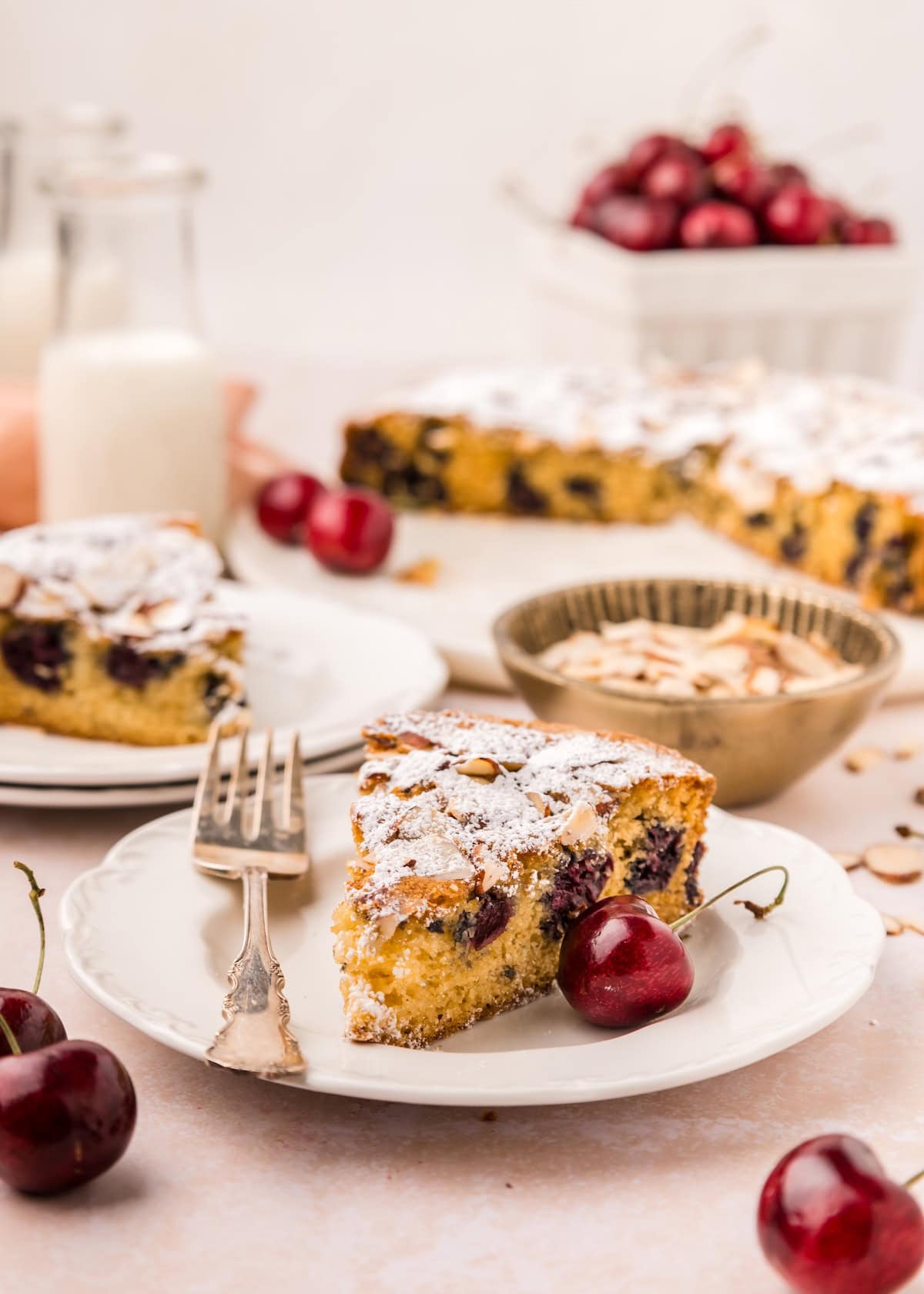 Slices of Cherry Almond Cake served on plates.