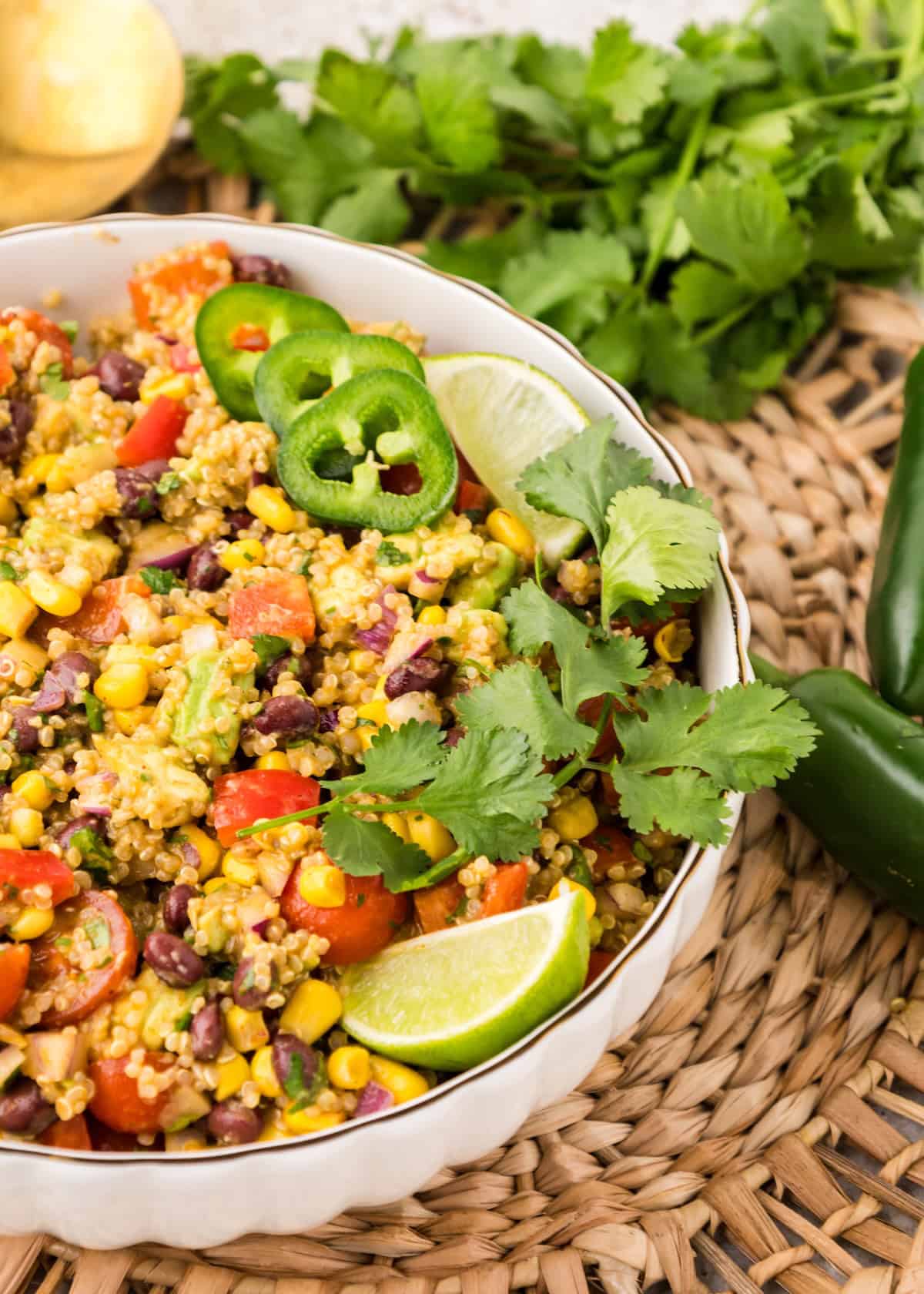 Southwest Quinoa Salad in a white bowl garnished with lime and cilantro.