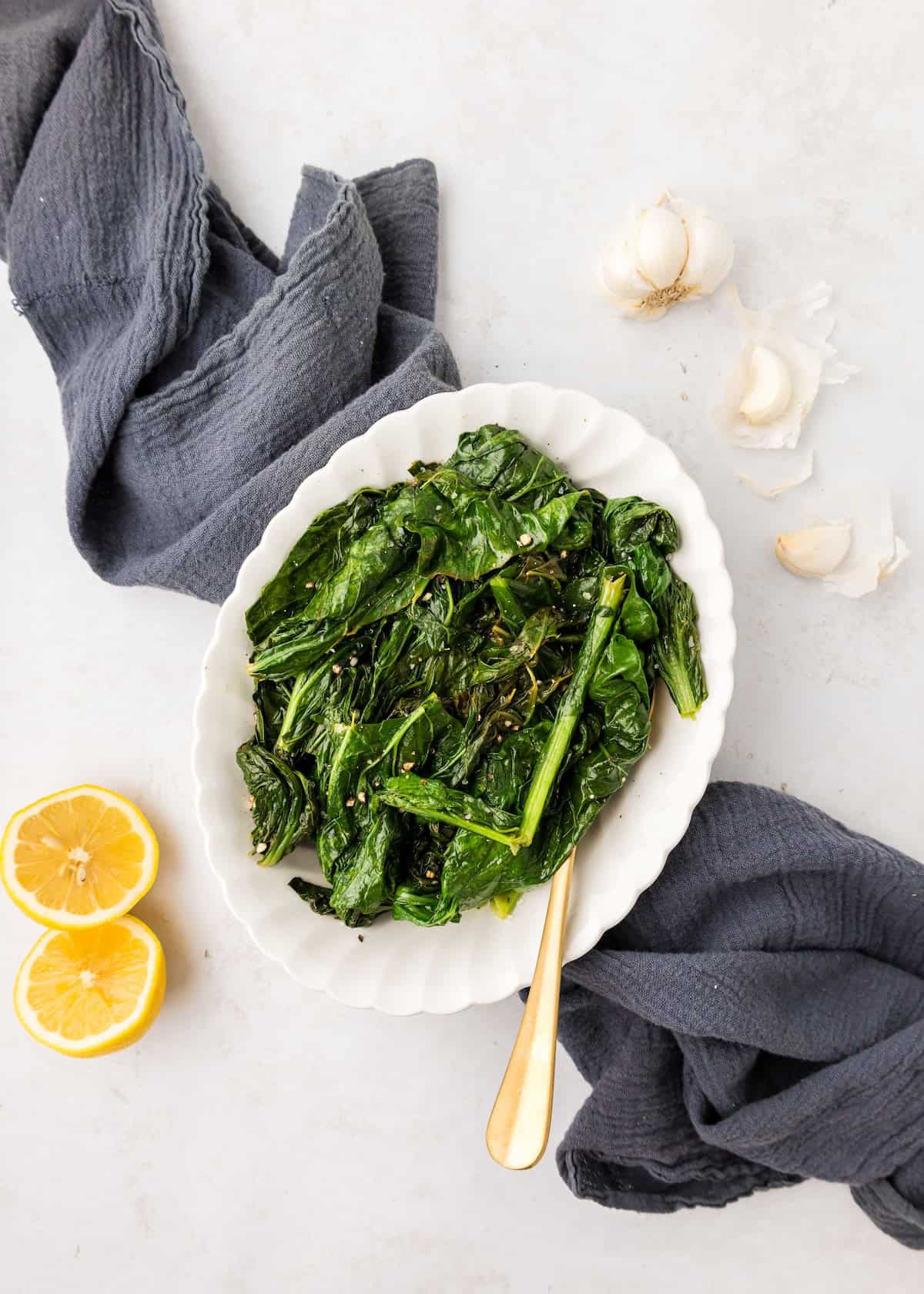 A white plate of Turnip Greens.