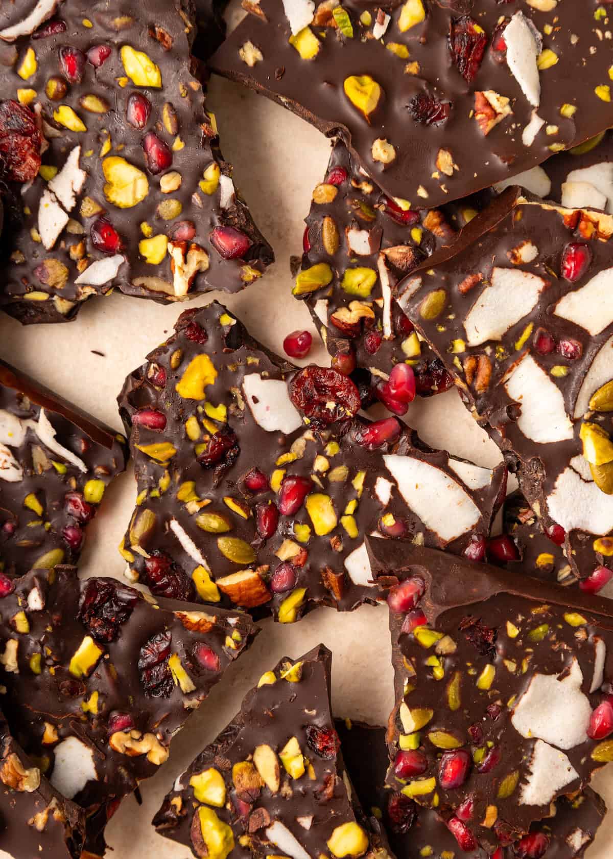 Dark Chocolate Bark with pistachios, coconut flakes, and dried fruit broken into pieces.