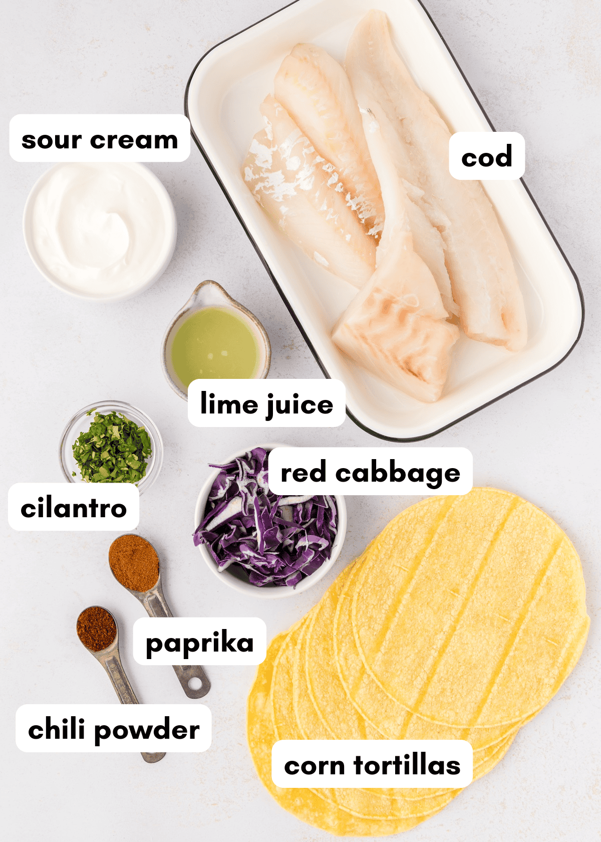Ingredients for fish tacos: cod, cabbage, spices, and Jalapeño Cheddar Cornbread on the side.
