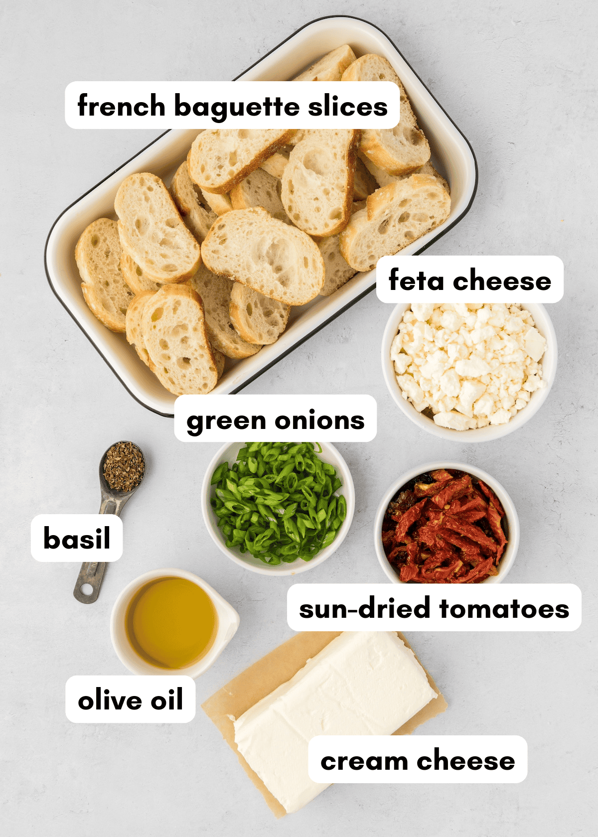 Sliced baguette, feta, green onions, basil, sun-dried tomatoes, olive oil, cream cheese.